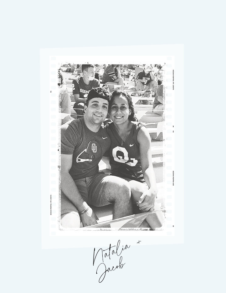 A black and white photo booth style portrait of engaged couple Natalia and Jacob smiling while sitting together in a stadium grandstand.