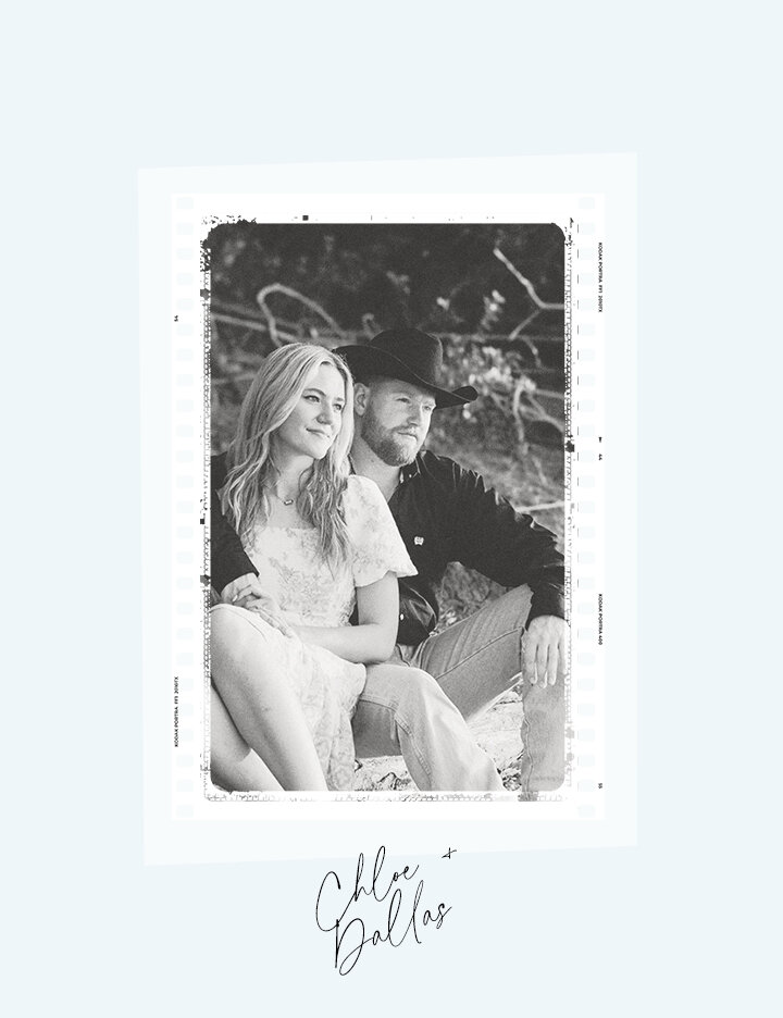 A black and white engagement photo of couple Chloe and Dallas sitting outdoors, with Dallas wearing a cowboy hat and Chloe leaning against him.