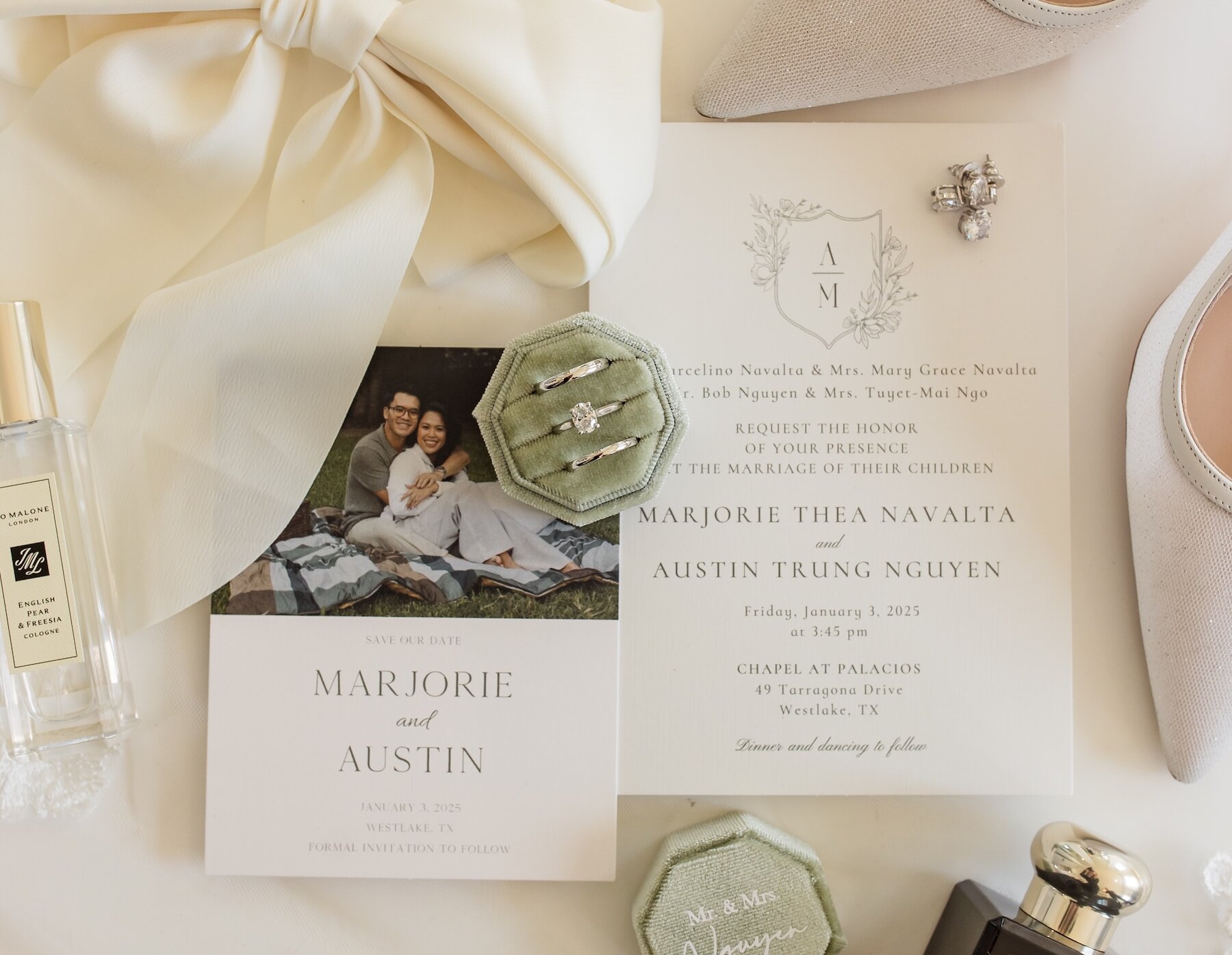 Artful collection of wedding rings, shoes, stationary and perfume selected for a wedding.