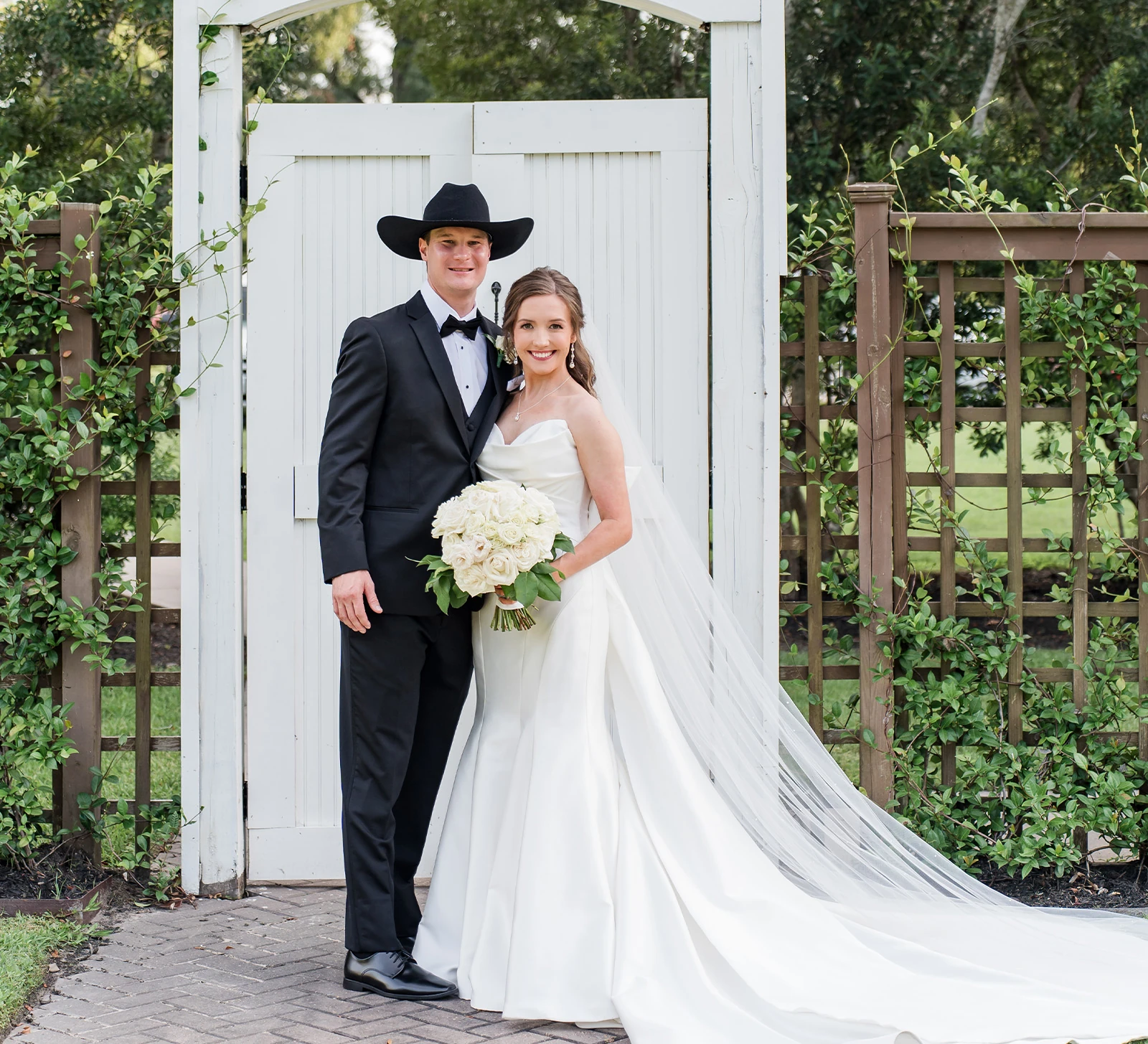 Bride and groom celebrating with raised joined hands during their wedding ceremony, smiling joyfully