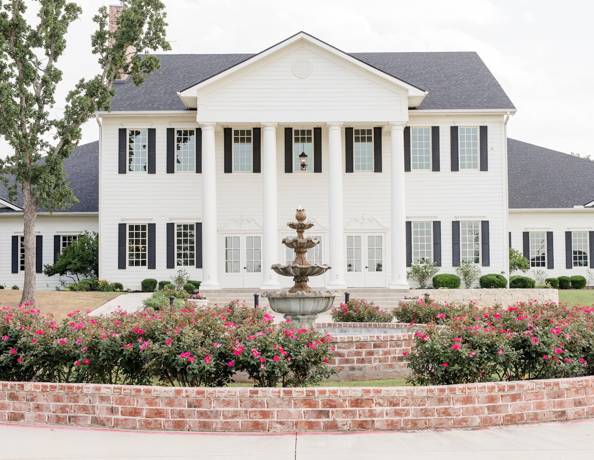 Fountain and flowers at the front entrance to the Milestone Mansion Wedding Venue