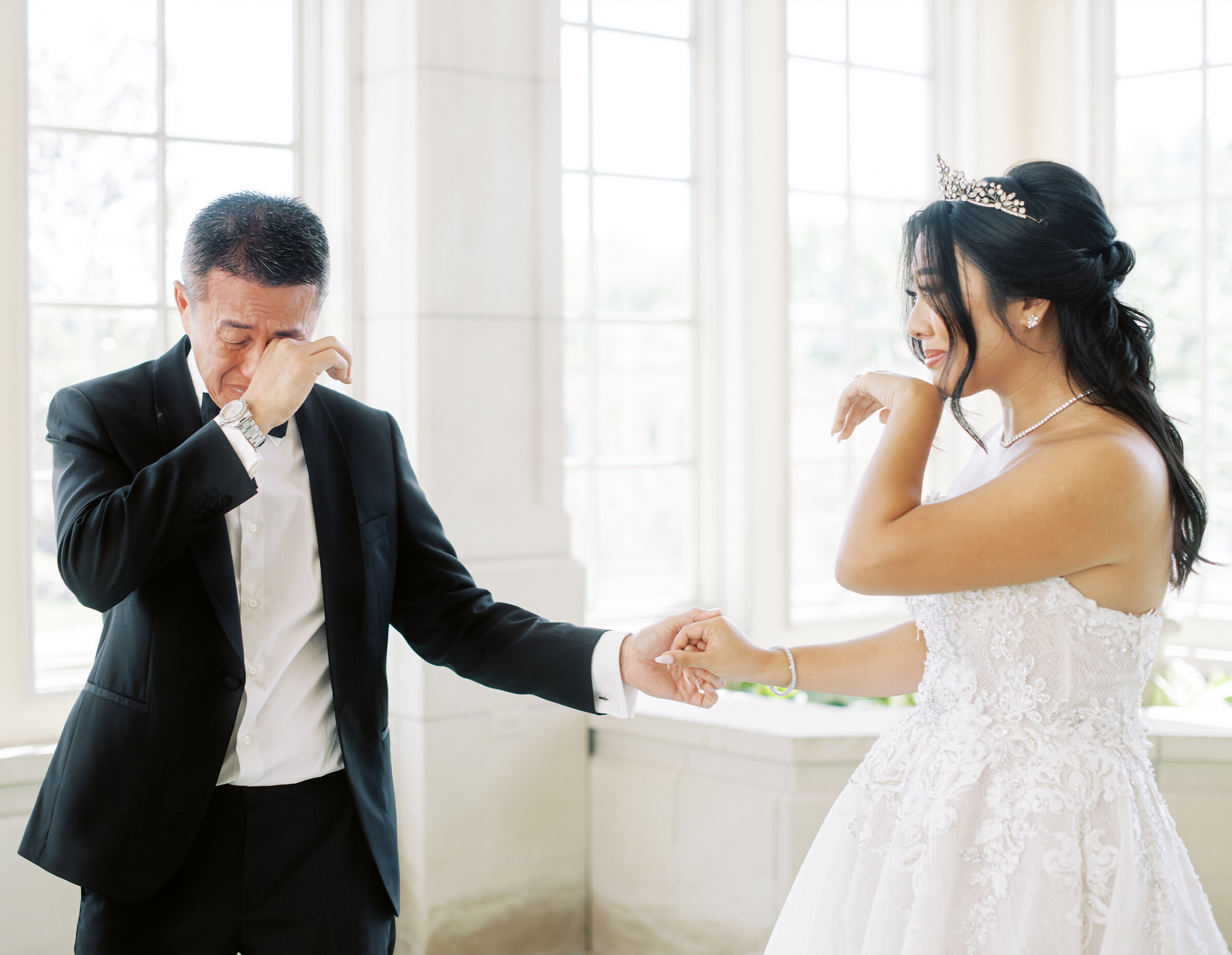 Bride and groom holding raised hands as they walk back down the aisle celebrating their marriage