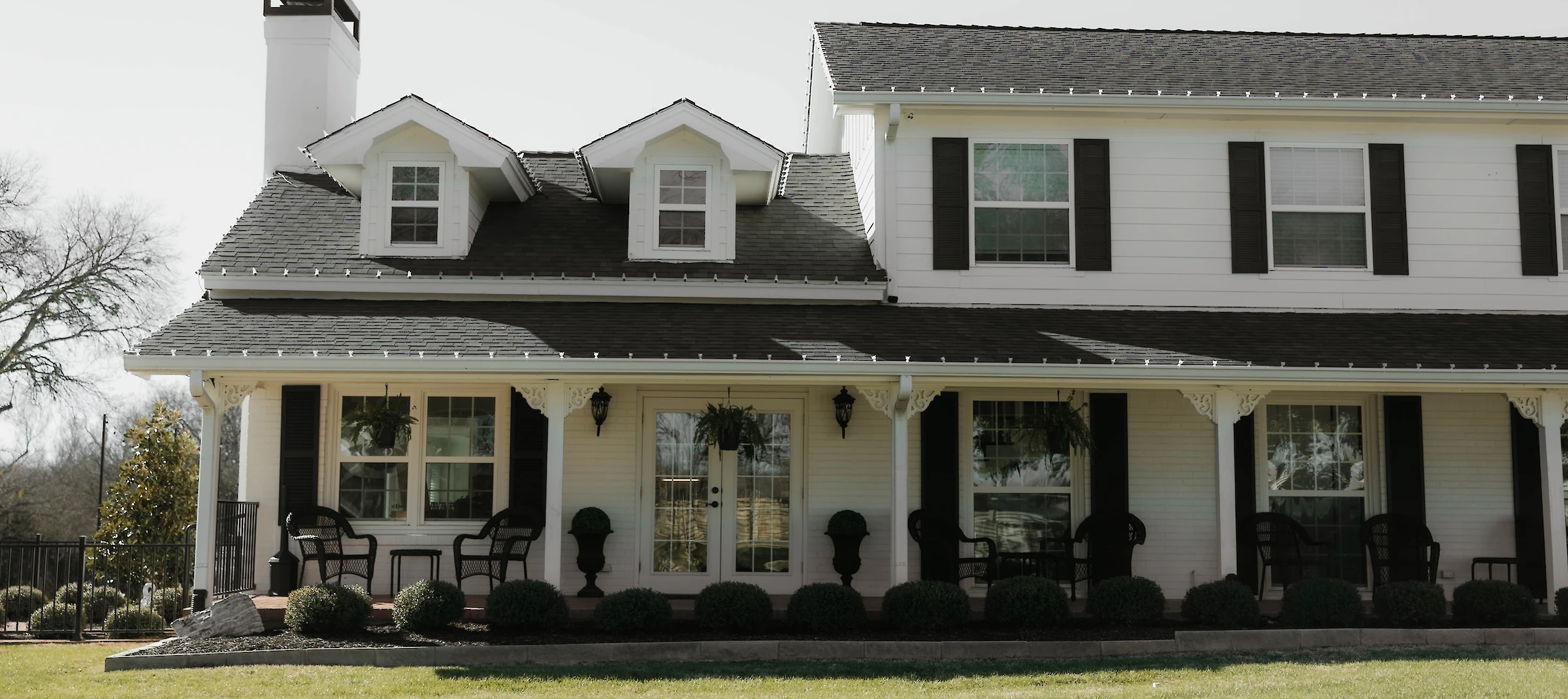 Wraparound porch with seating at Firefly Gardens Wedding Venue