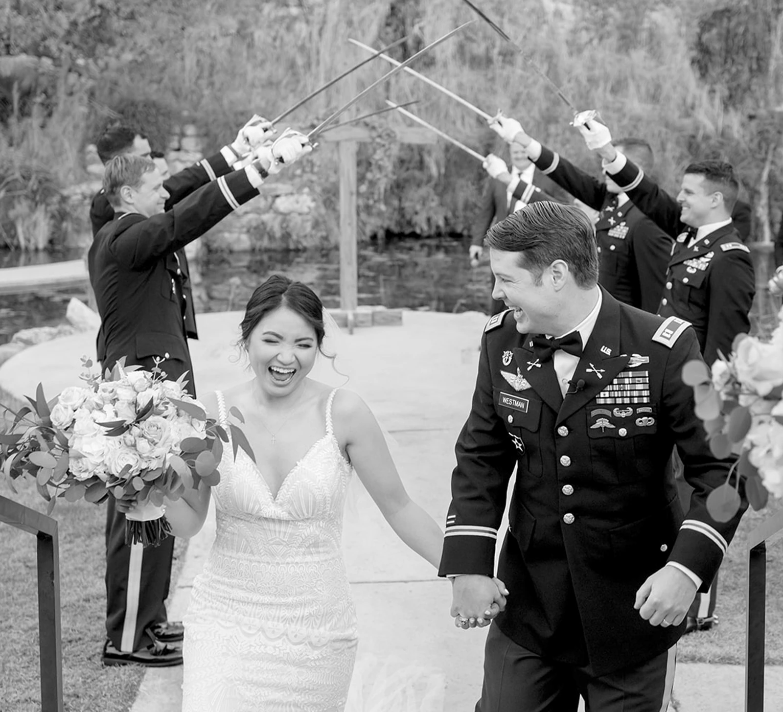 Bride holding a white rose bouquet, holding the groom's hand.