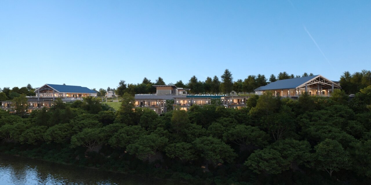 An architectural rendering of The Laiken wedding venue and villas complex nestled among trees on a hillside above a body of water at dusk.