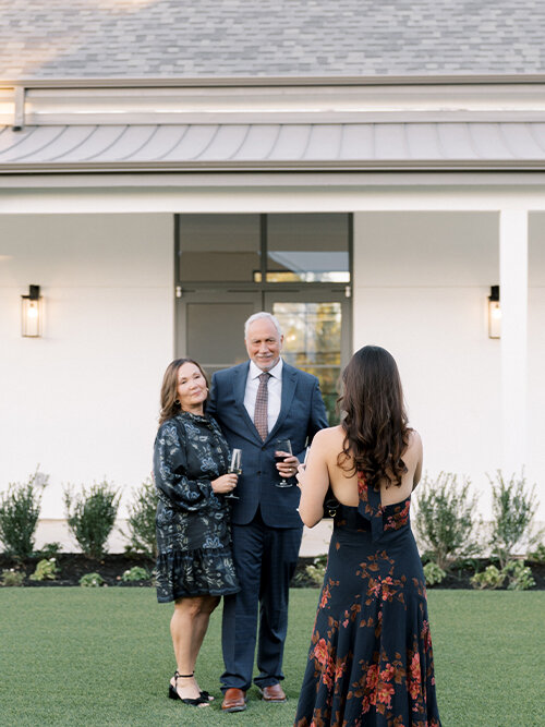 Bright outdoor portrait of a joyful bride and groom dancing in a park or field at sunset, with the bride holding a bouquet and wearing a dress with puff sleeves