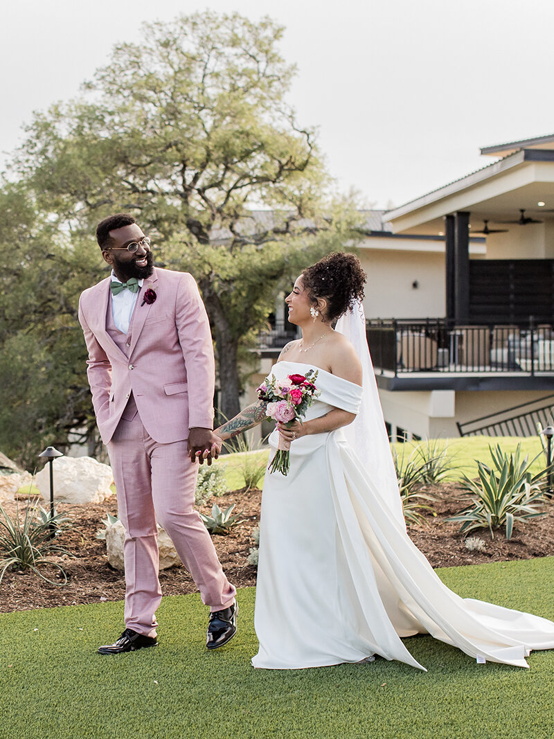 Bride and groom holding hands, walking outside after "I do"