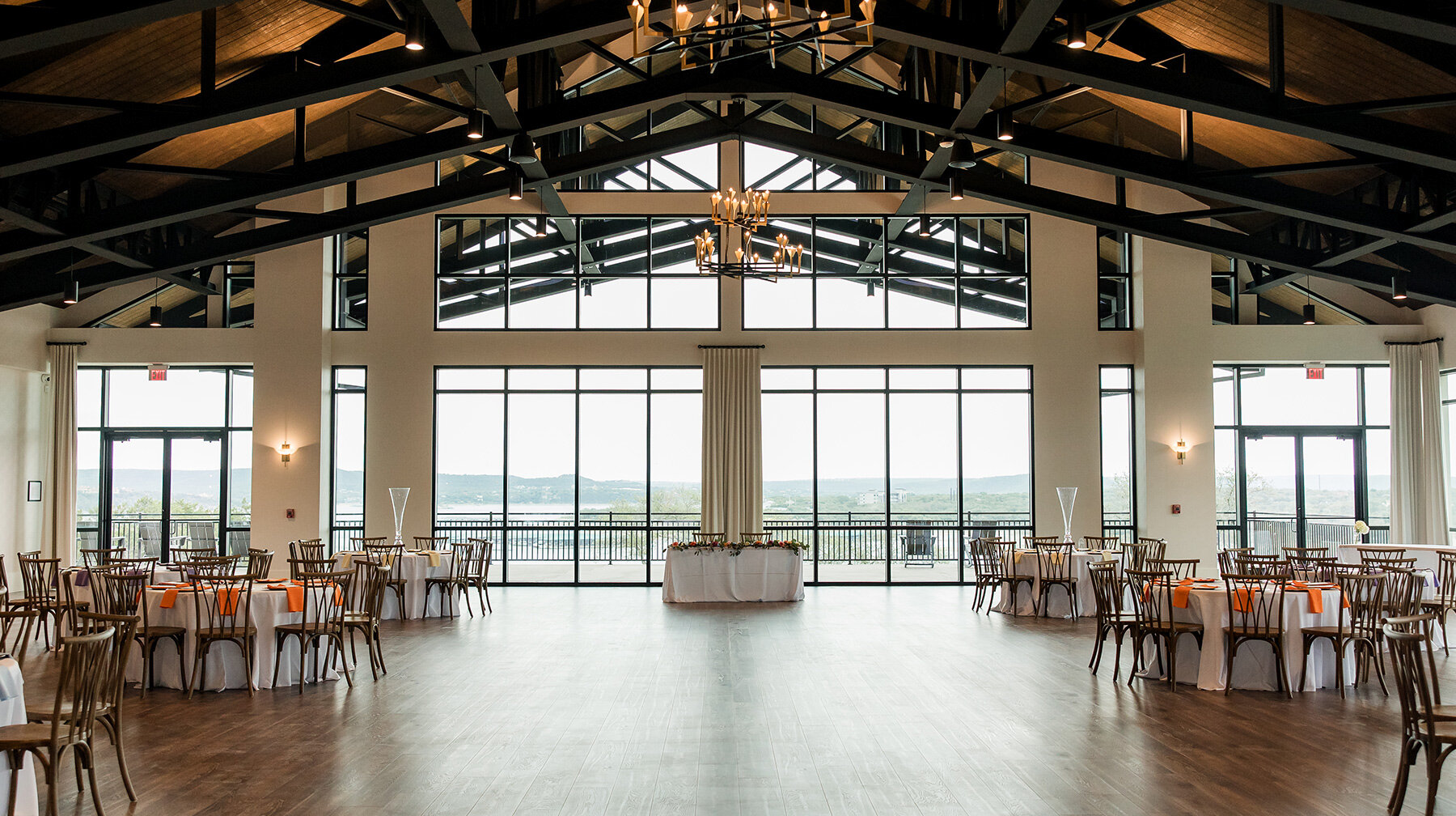 Wide view of reception hall with large windows overlooking the lake