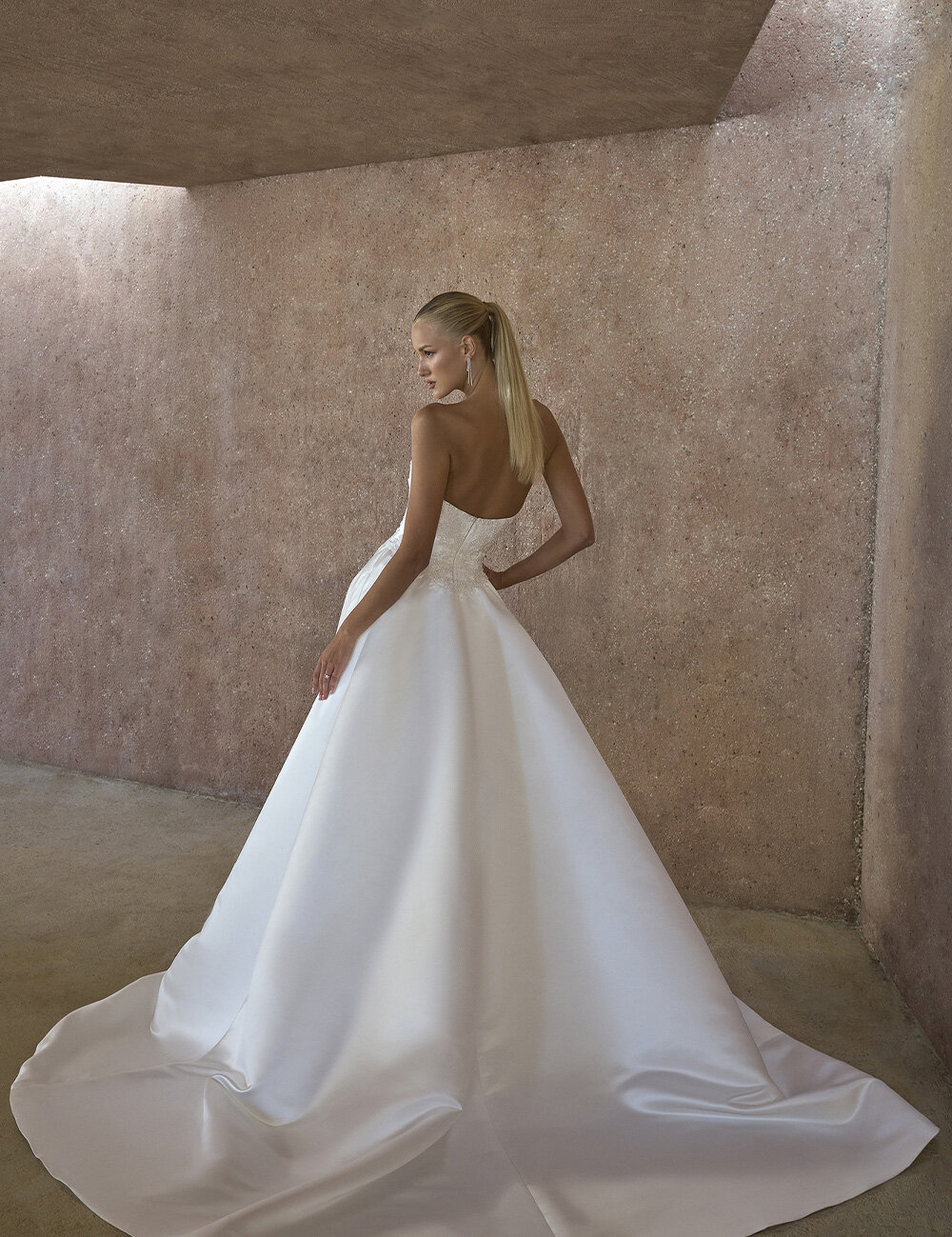 long wedding gown and bride looking backwards