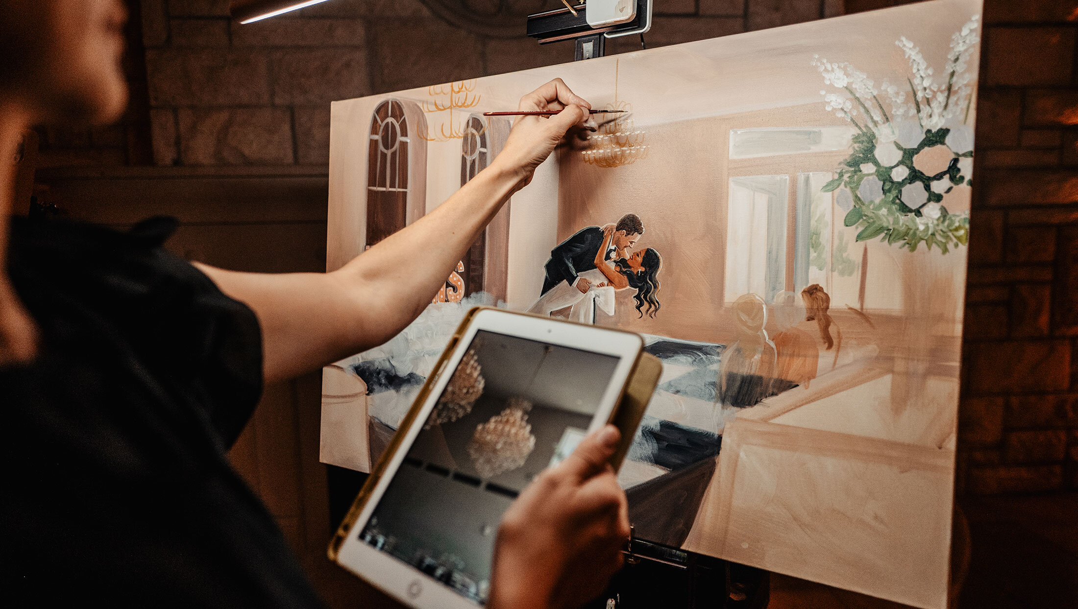 artist painting a couple kissing during wedding ceremony
