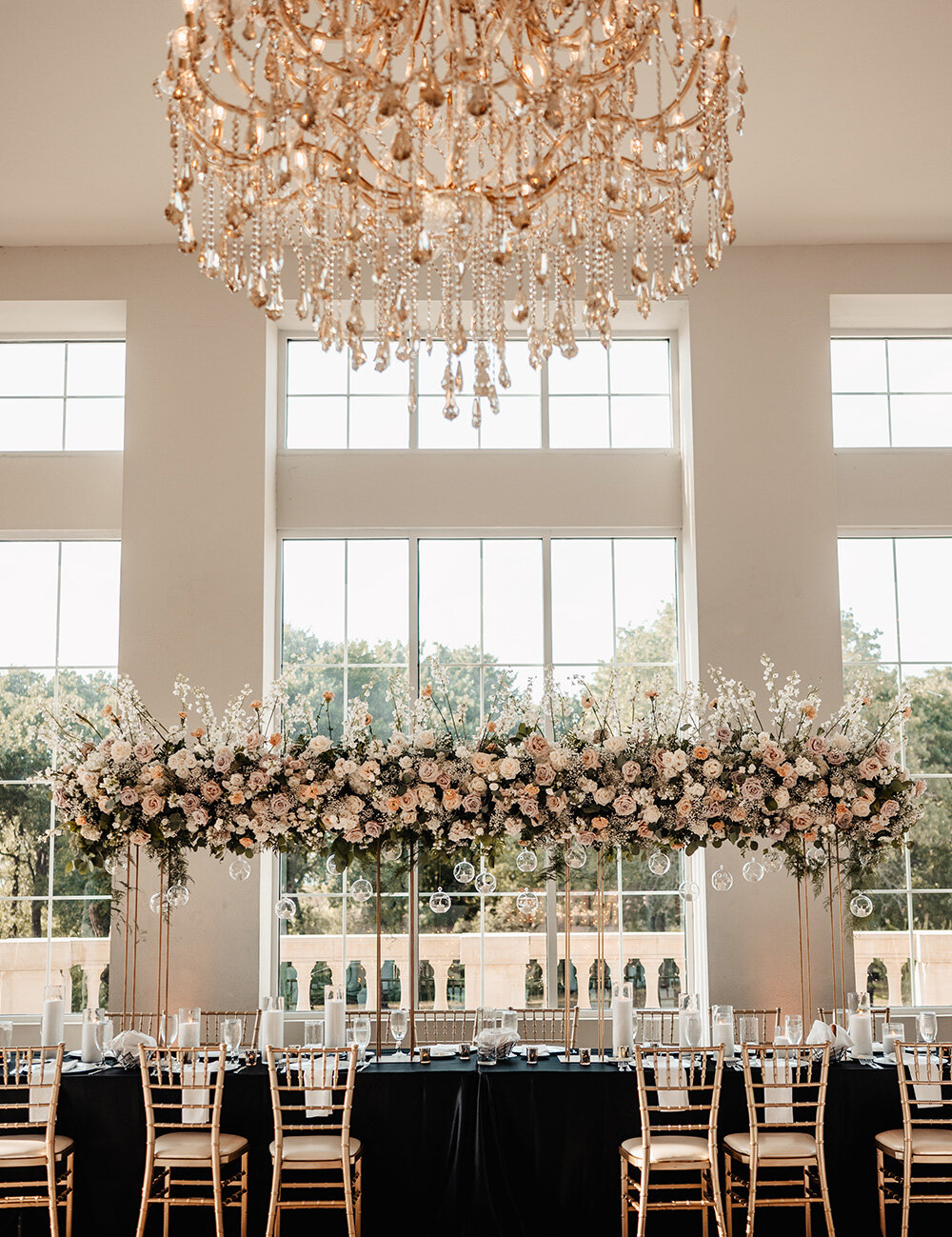 table at wedding reception with blush florals