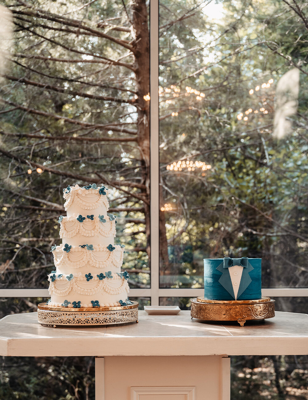 two cakes with white and blue frosting