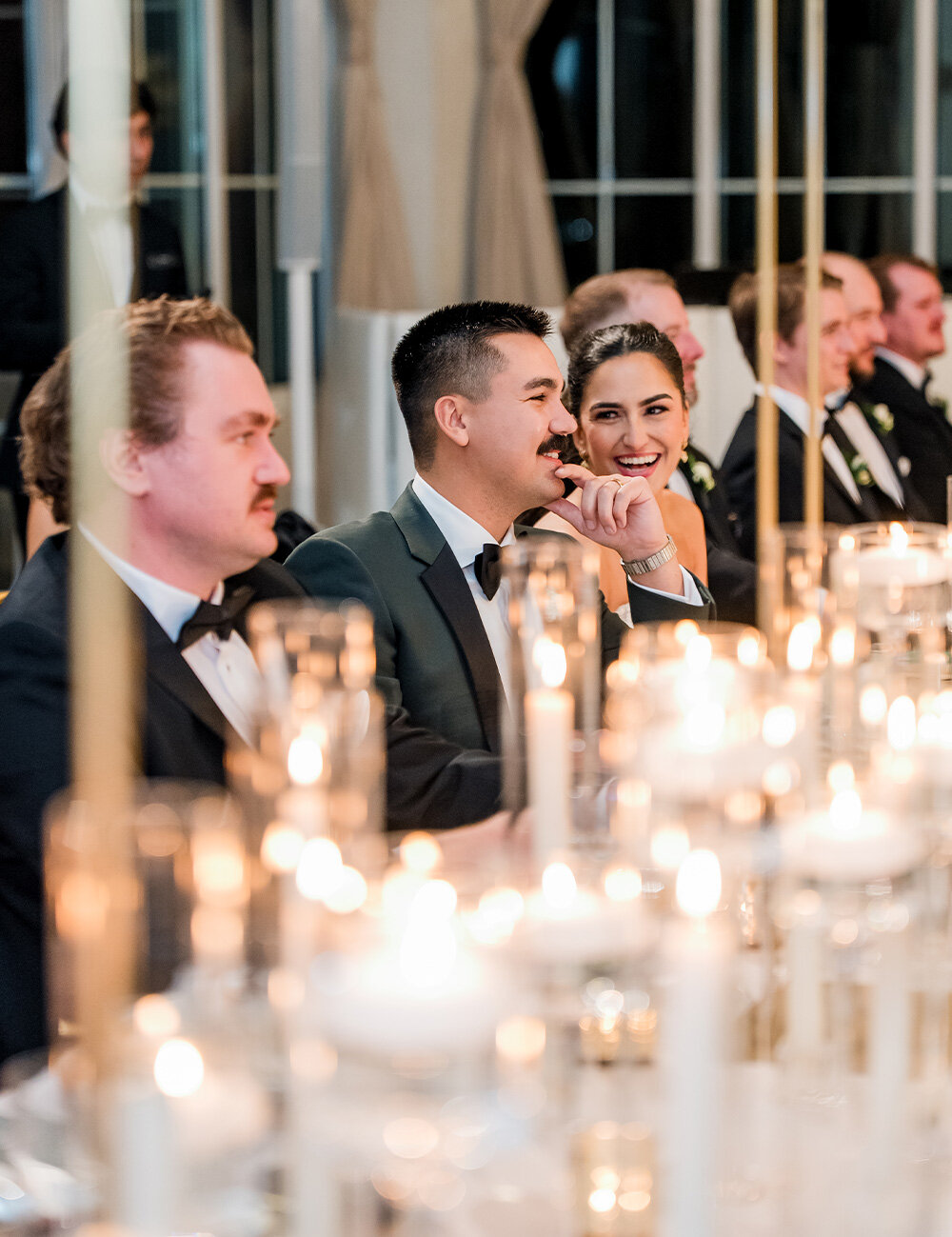 couple smiling at wedding table