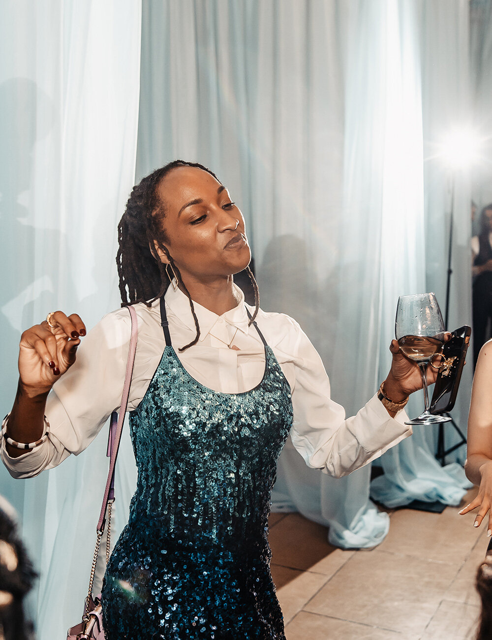 woman dancing with drink in hand