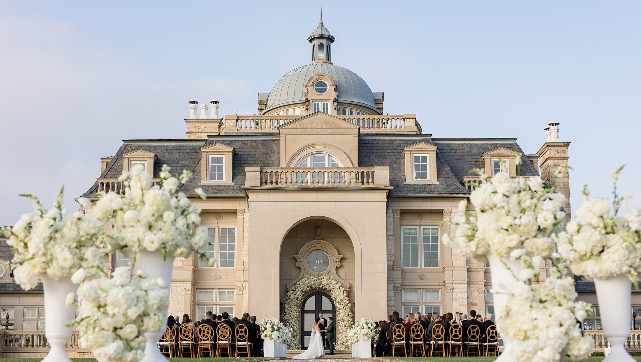 outside ceremony shot in front of mansion