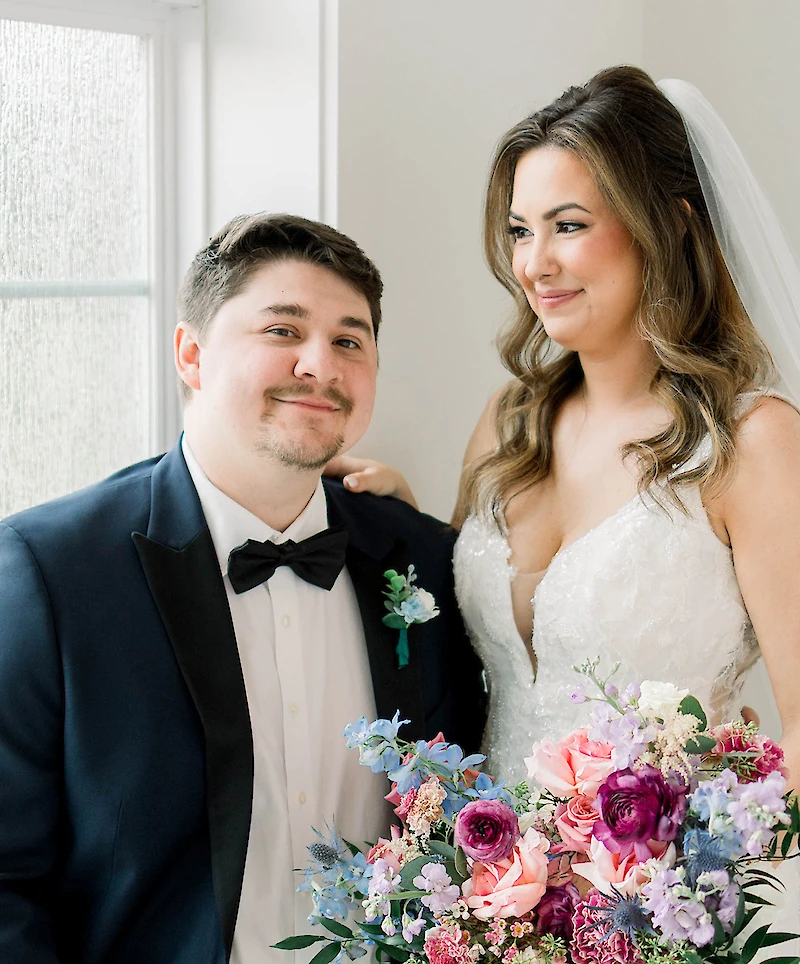 bride looking down and groom smiling