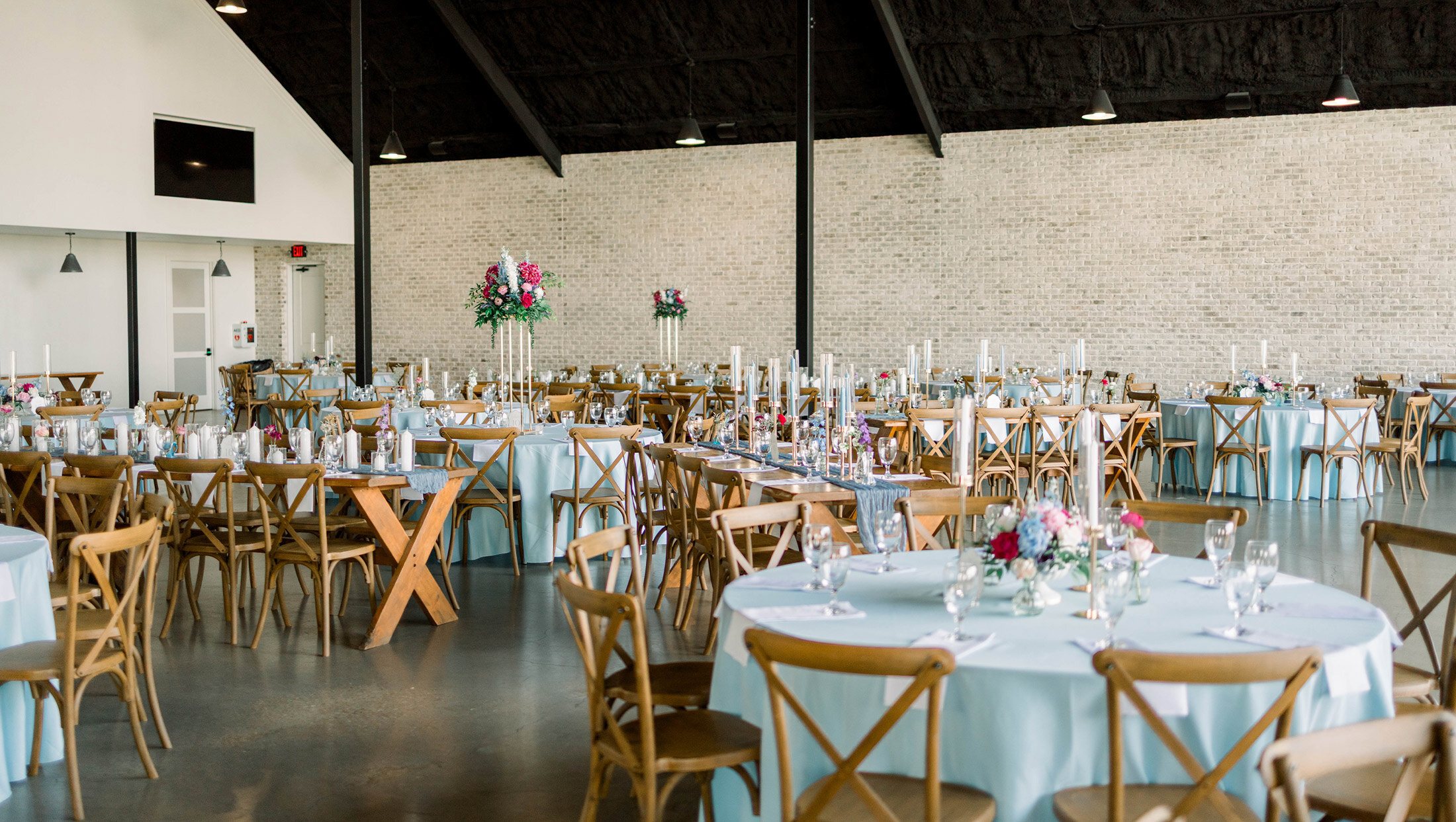 inside reception tables with blue tablecloths
