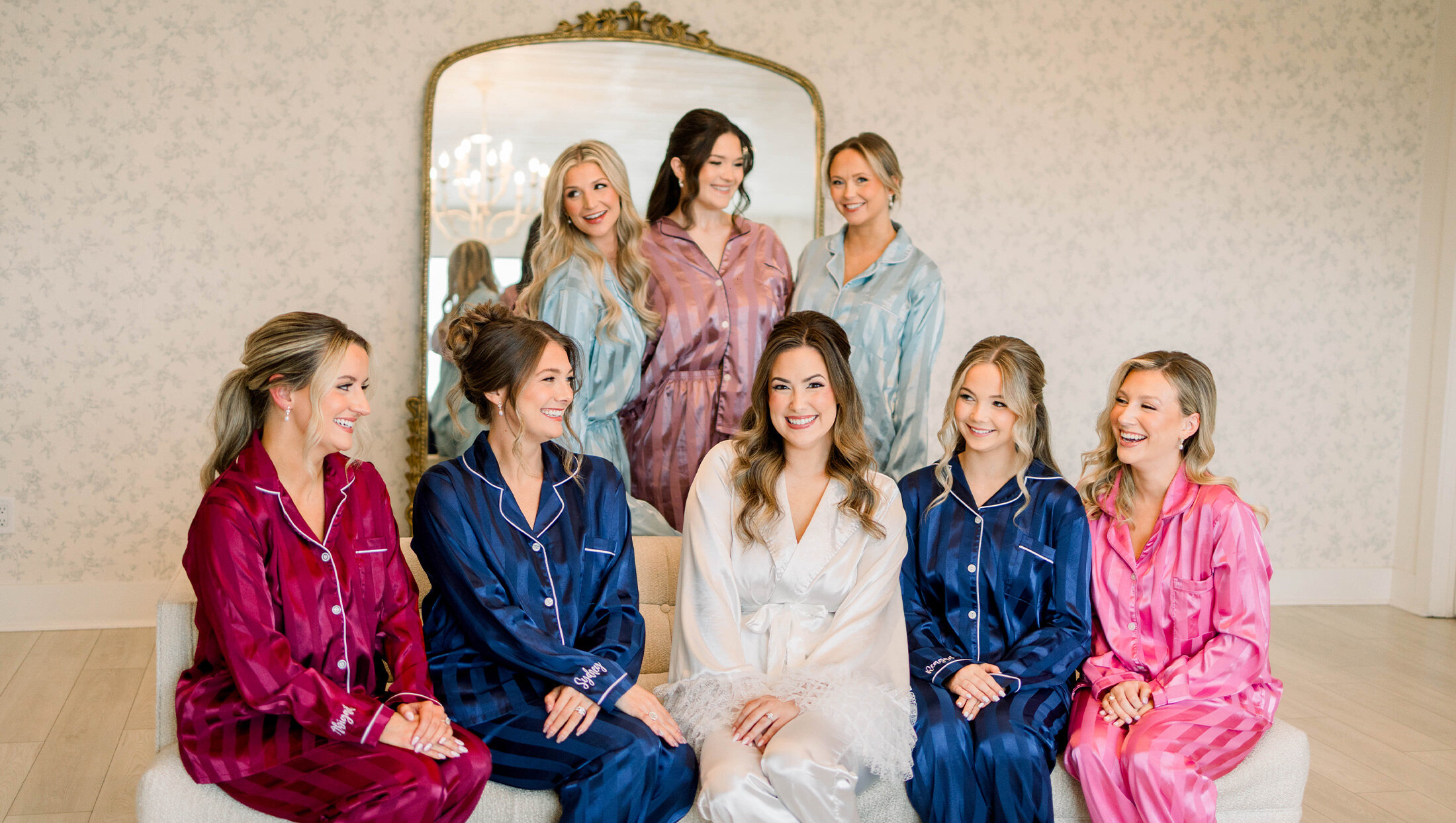 bridal party getting ready and smiling at eachother