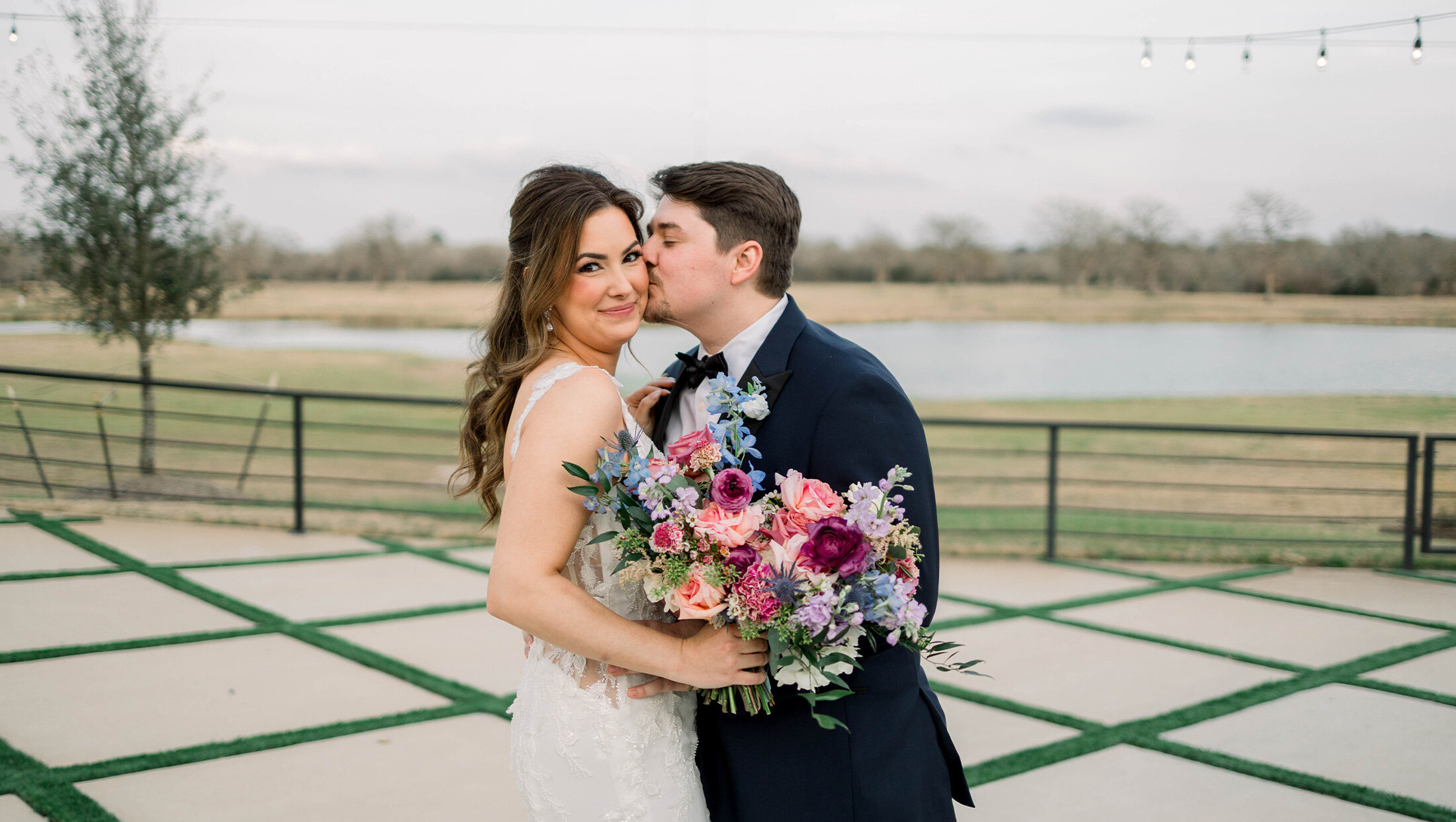 groom kissing bride on cheek