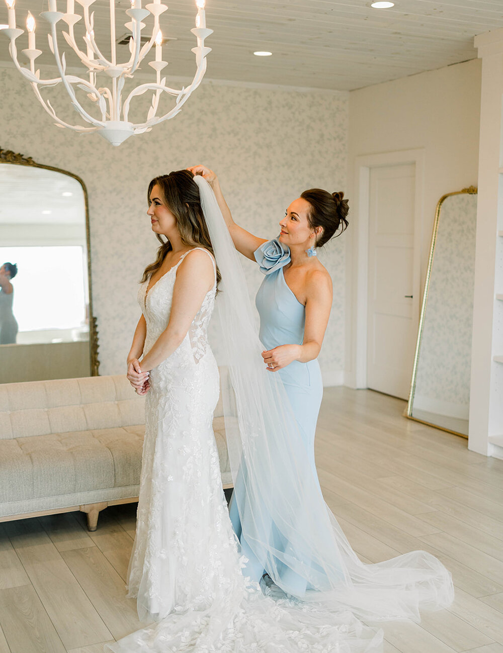 mother of bride placing veil on head