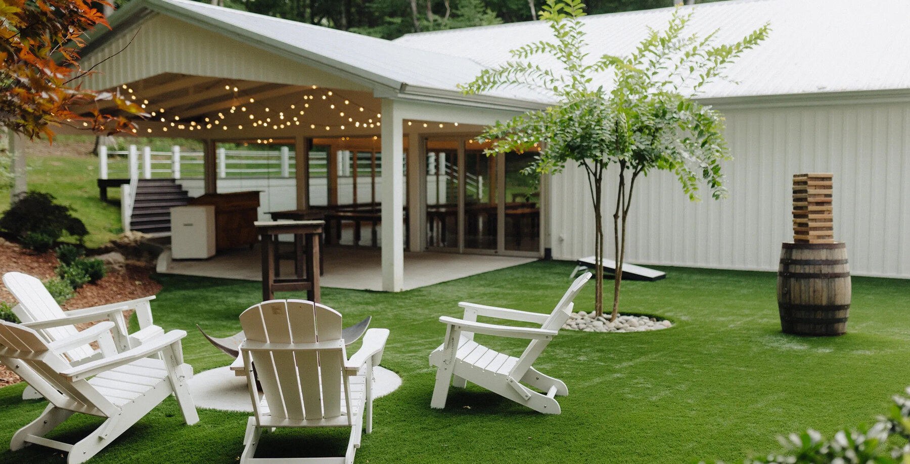 outdoor cocktail space with yard games and patio and string lights