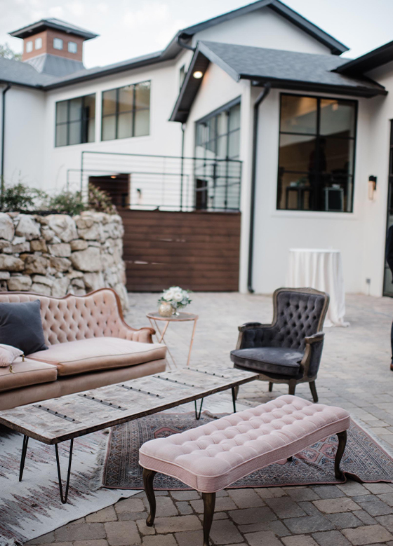 Outdoor seated reception area with couches and chairs