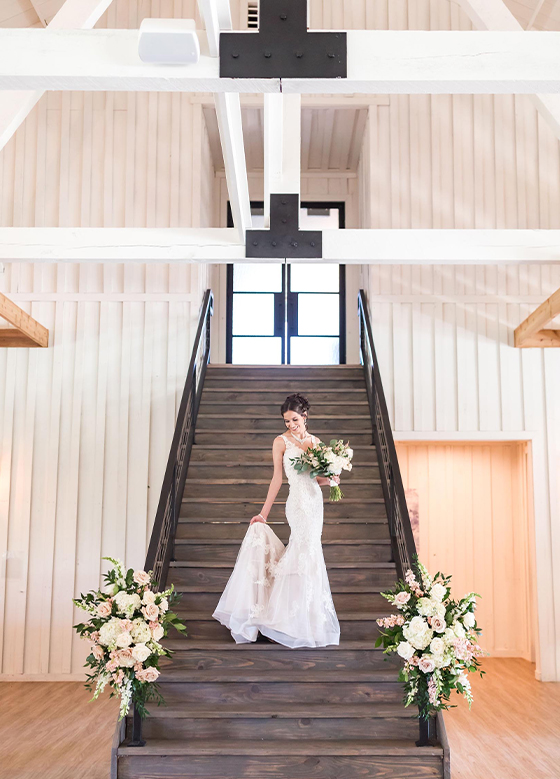 Bride with bouquet on staircase
