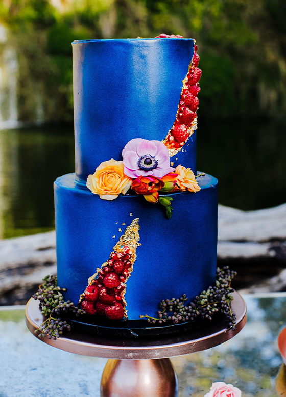 Vibrant blue cake decorated with floral accents