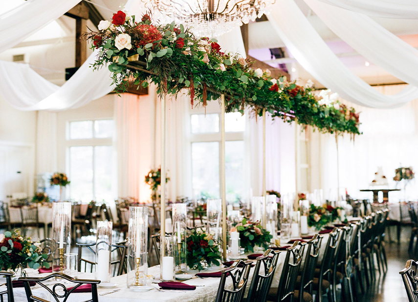 Wedding reception table with hanging floral arrangements