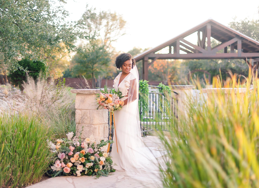 bride holding flowers on walkway