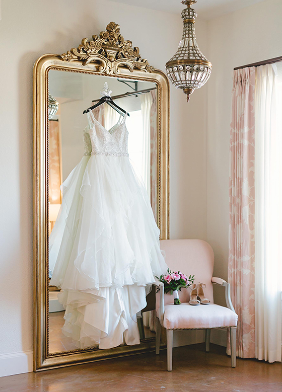 Close up of wedding gown hanging on mirror