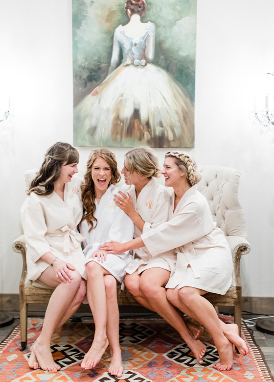 bride and bridesmaids getting ready together