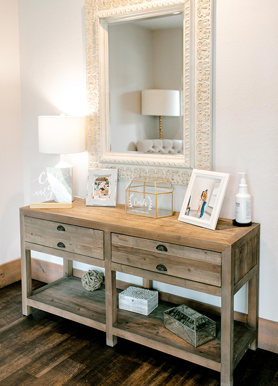 Close up of getting ready suite wood side table with white mirror above