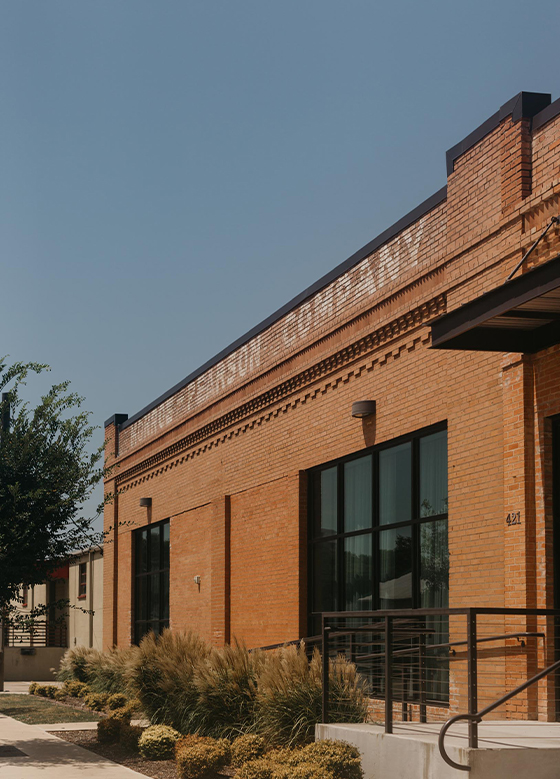 Exterior of modern brick building with black accents and large windows