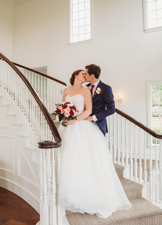 Bride and Groom Kiss on Spiral Staircase