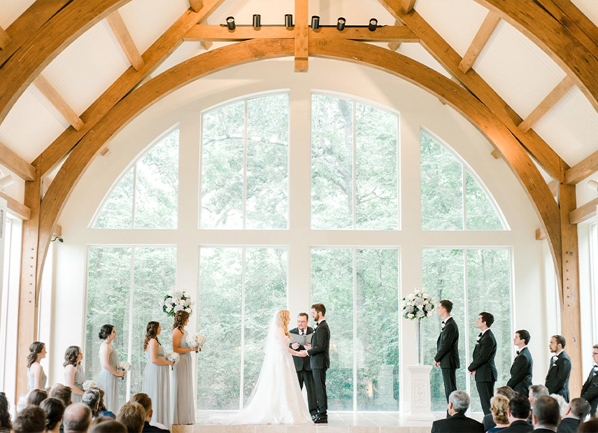 Beautiful Vibrant Green Outdoors Behind Floor to Ceiling Windows Chapel Ceremony