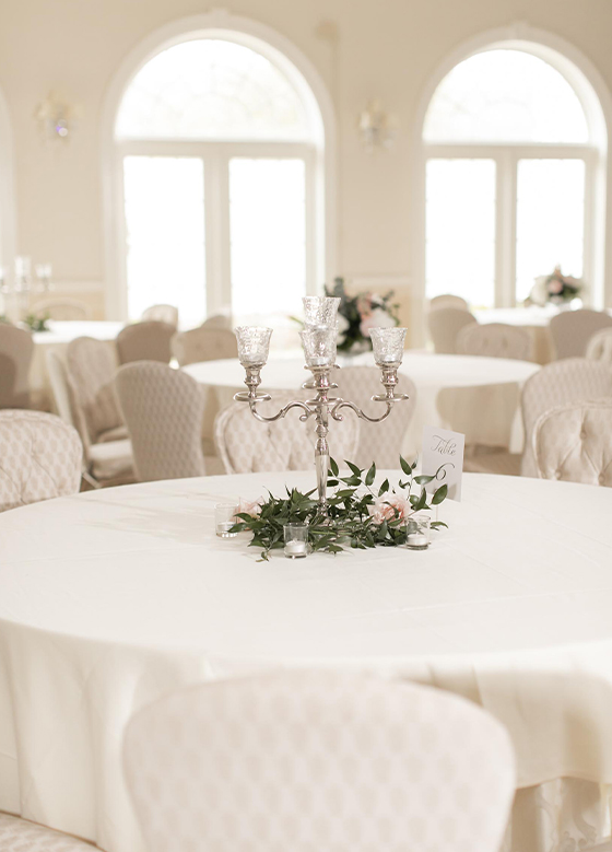 Wedding reception table decorated with floral arrangement