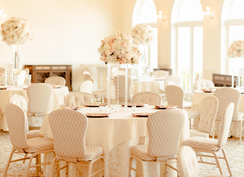 Wedding reception tables in sun-filled room