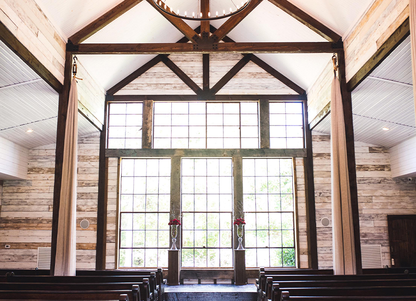 Large sunlit windows at the front of wedding ceremony space
