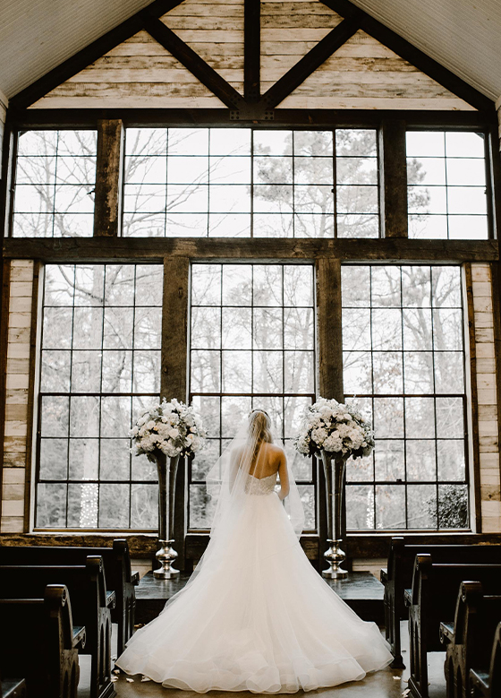 Bride from behind in front of large windows