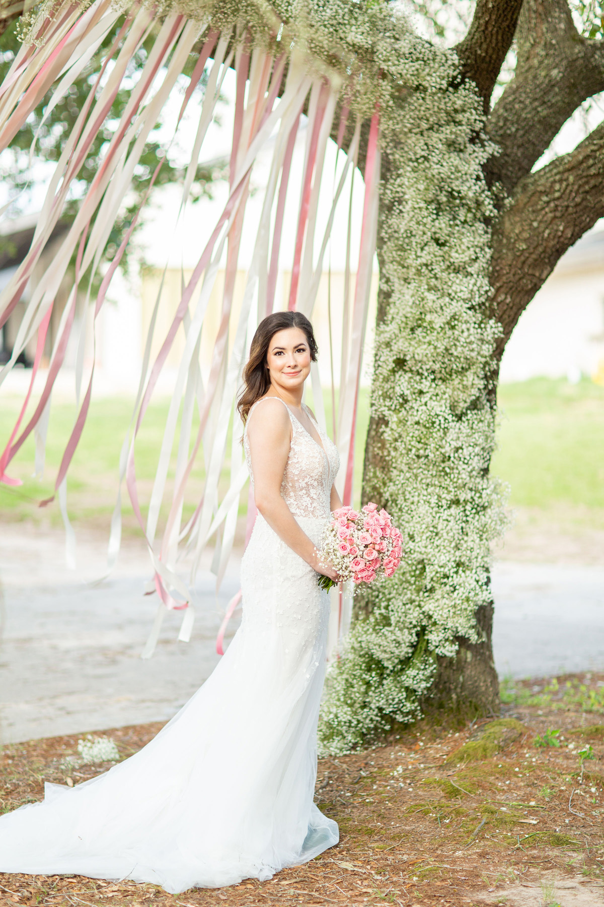 Bride Holding Bouquet Floral Covered Tree Lakeside