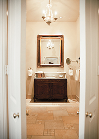 Wildwood inn denton lodging master bathroom open door into antique mirror and sink