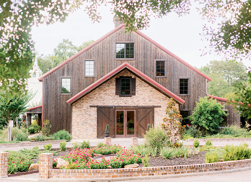 The Carriage House Rustic Barn Stone Wood Exterior Double Doors Surrounding Garden