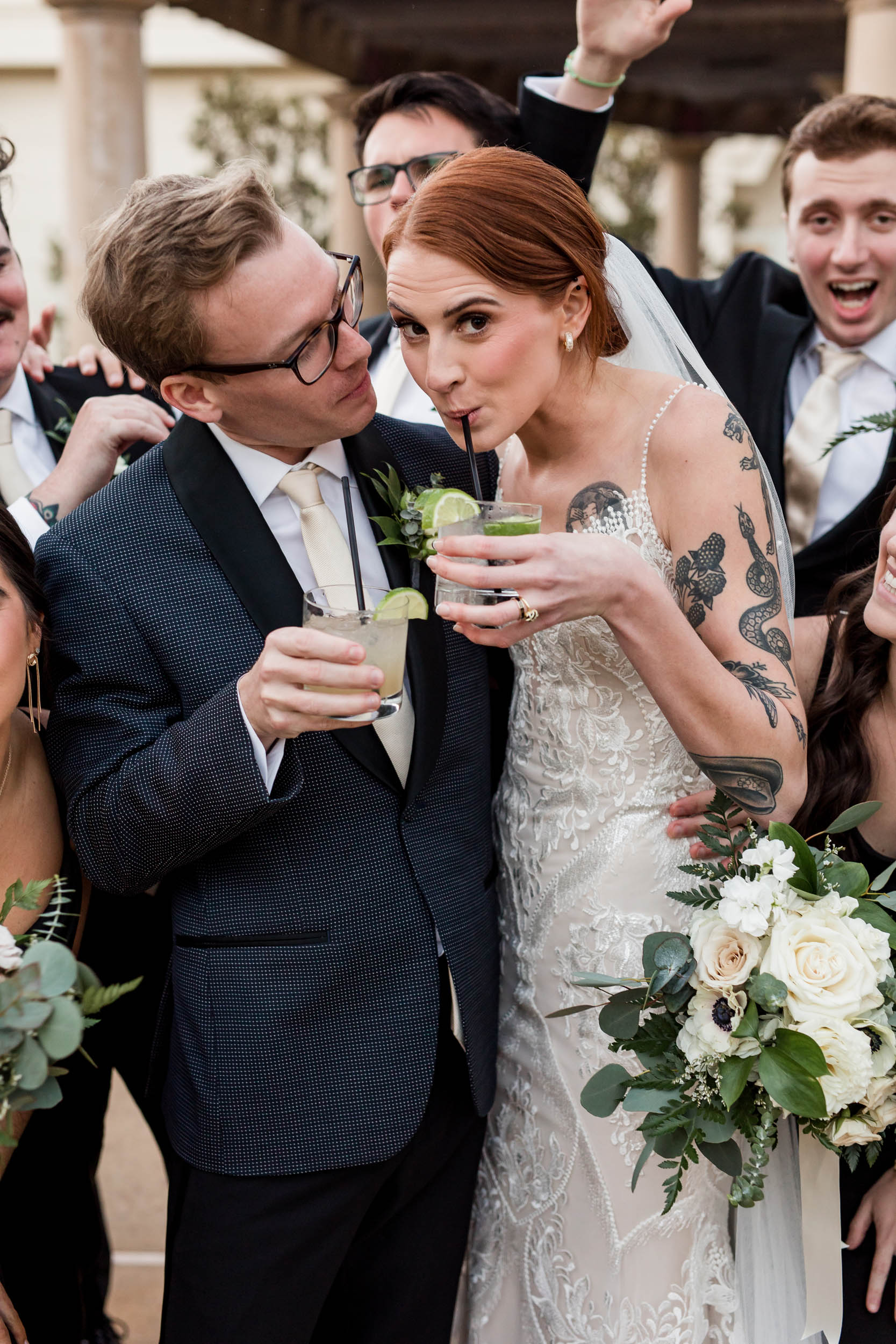 Bride Sipping Cocktail Playfully Groom Wedding Party Celebrating
